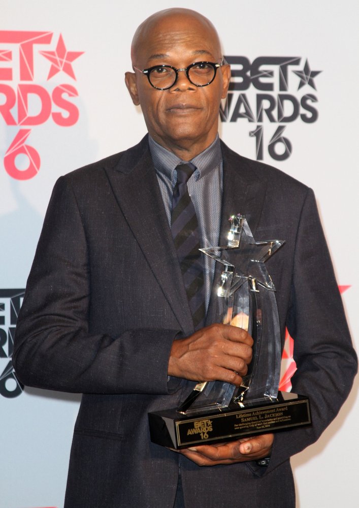 PHOTO: Samuel holding his Award. Photo Credits: aceshowbiz.com